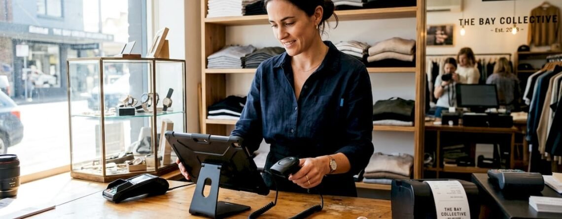 Retail worker setting up POS system on counter
