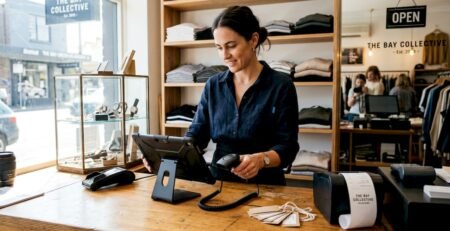 Retail worker setting up POS system on counter